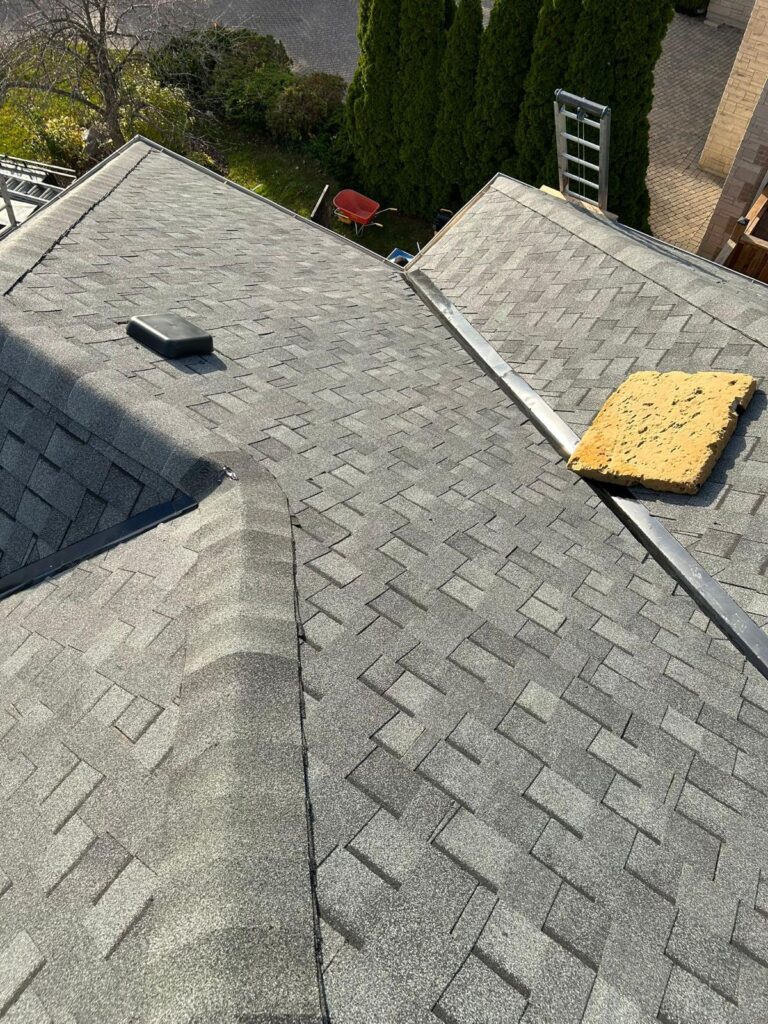 Grey shingles covering adjoining roof slopes